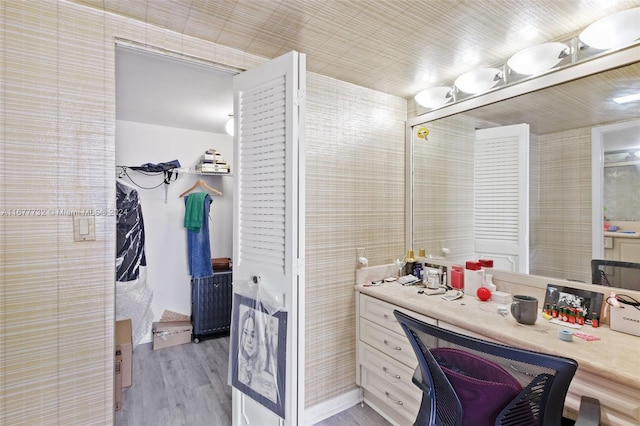 bathroom with hardwood / wood-style floors and vanity