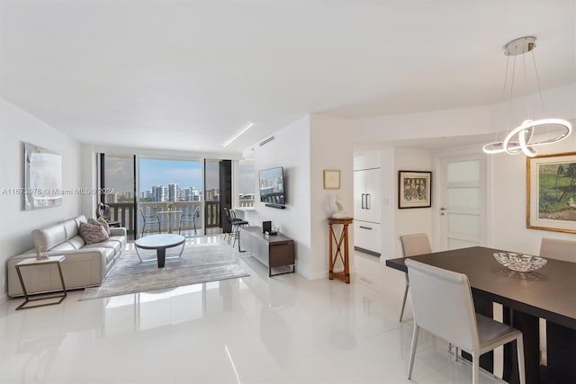 living room featuring light tile patterned flooring, a chandelier, and floor to ceiling windows