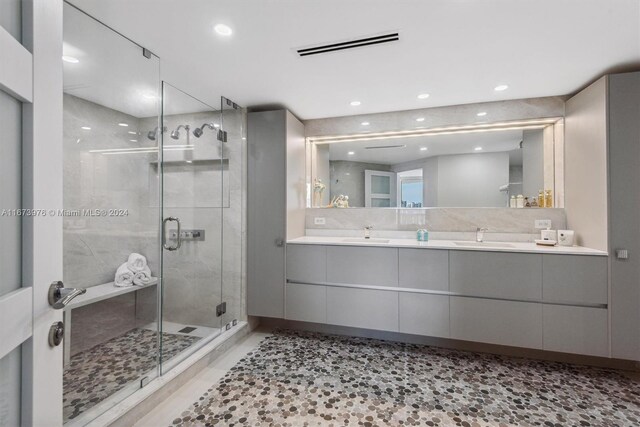 bathroom featuring vanity and a shower with shower door