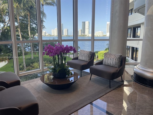 3000 Island Blvd Unit 2404, Aventura, FL 33160 - living area featuring marble tiled flooring, a skyline view, a water view, and plenty of natural light
