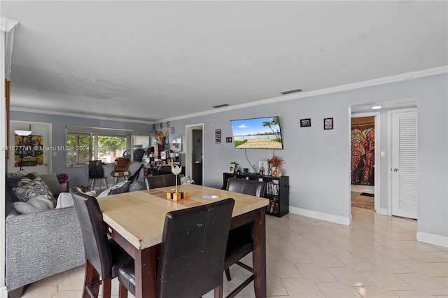 dining space featuring crown molding