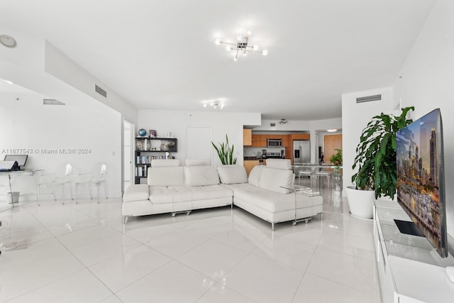 living room with a notable chandelier and light tile patterned floors