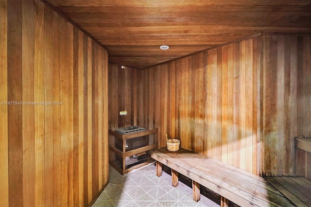 view of sauna with wooden walls and wood ceiling