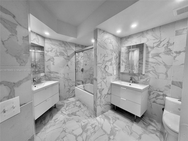 full bathroom with vanity, tile walls, and toilet