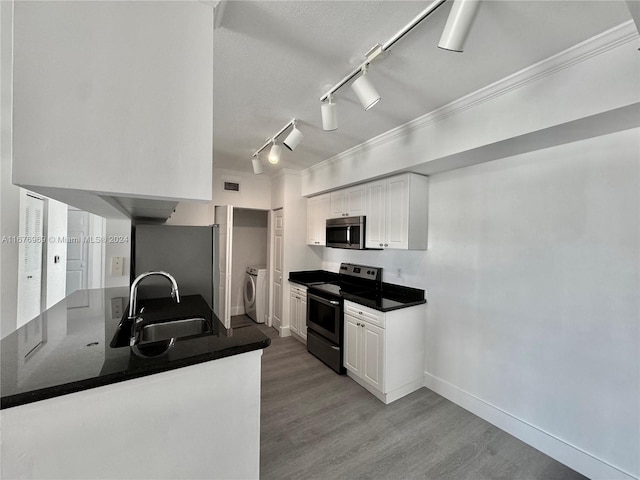 kitchen with light hardwood / wood-style floors, stainless steel appliances, sink, and white cabinets