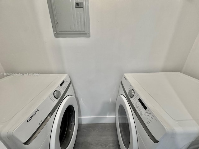 laundry room with independent washer and dryer, hardwood / wood-style flooring, and electric panel