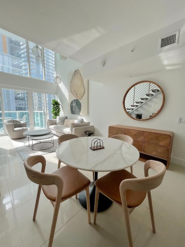 dining area featuring light tile patterned flooring