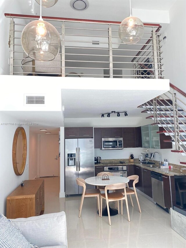 dining space featuring light tile patterned floors and sink