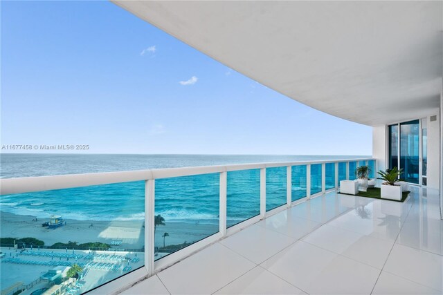 dining room featuring a water view, light tile patterned floors, and an inviting chandelier