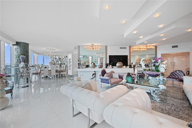 living area with visible vents and an inviting chandelier