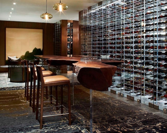 wine room featuring marble finish floor and a dry bar