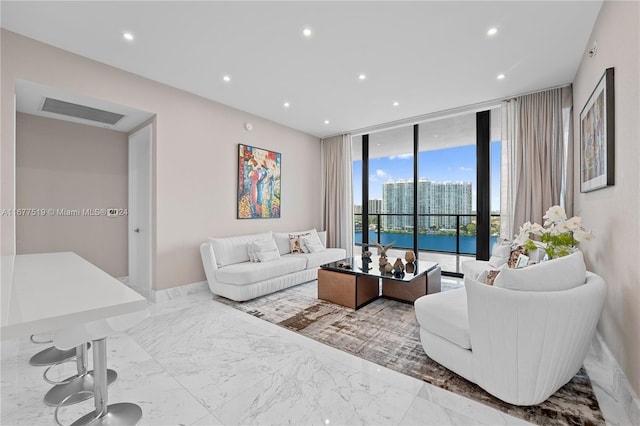 living room with expansive windows and a water view