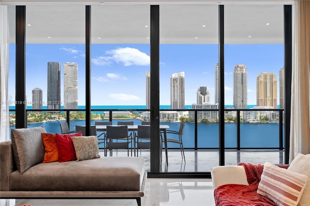 living room featuring expansive windows and a water view