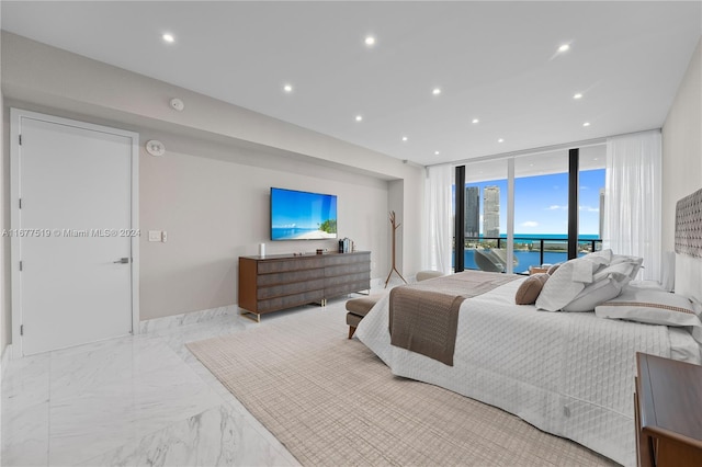 bedroom featuring access to outside and floor to ceiling windows