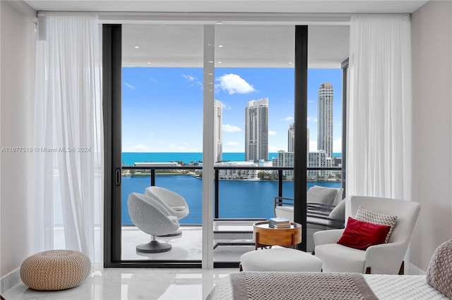 living room with a water view and floor to ceiling windows