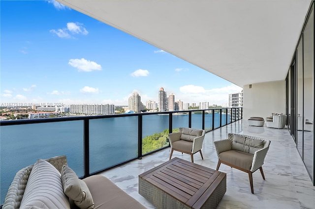 balcony with an outdoor living space and a water view