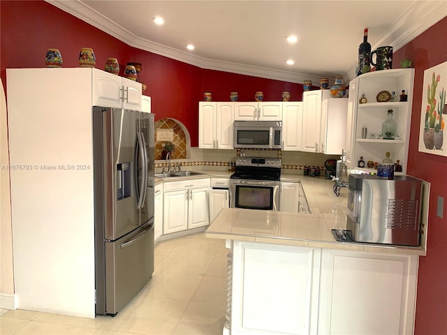 kitchen with kitchen peninsula, appliances with stainless steel finishes, white cabinetry, and sink