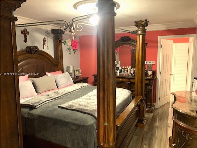 bedroom featuring ornate columns, dark wood-type flooring, and ornamental molding