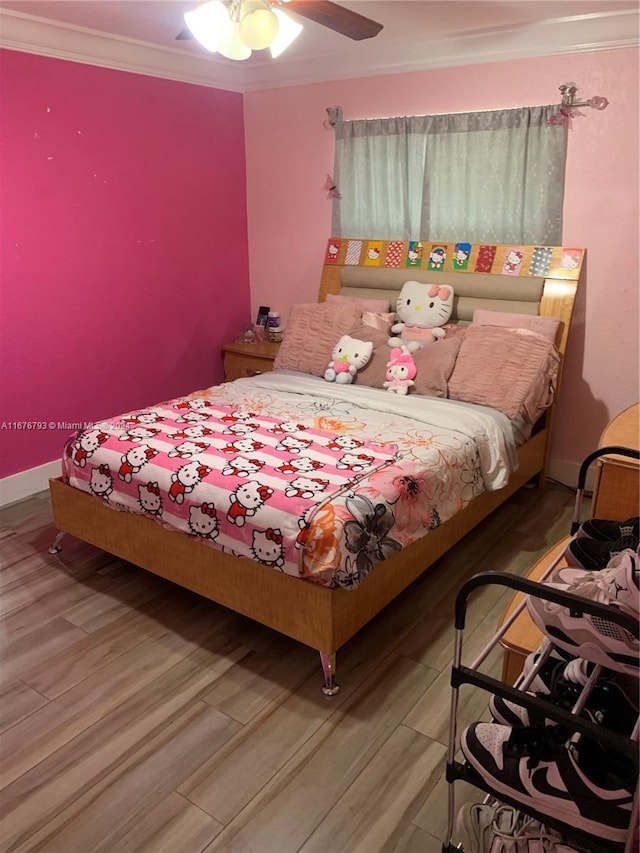 bedroom with ceiling fan, ornamental molding, and hardwood / wood-style flooring