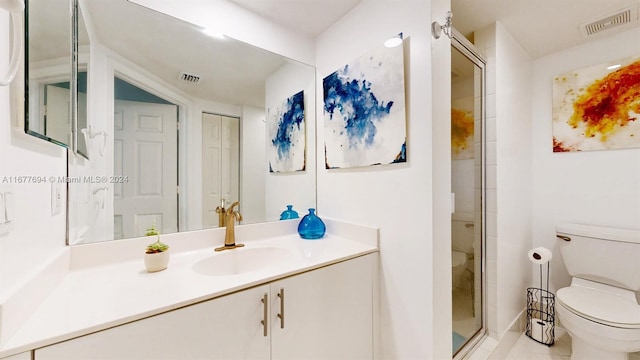 bathroom featuring vanity, a shower with shower door, toilet, and tile patterned floors