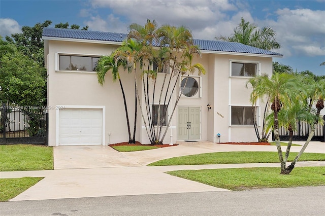 view of front of house with a front lawn and a garage