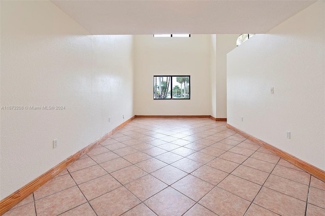 unfurnished room featuring light tile patterned flooring