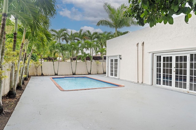 view of pool featuring a patio area and french doors