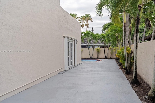 view of patio / terrace featuring french doors and a fenced in pool