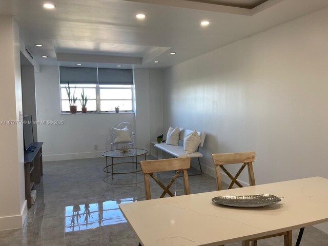 dining area featuring a raised ceiling