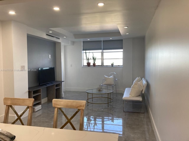 living room featuring a raised ceiling