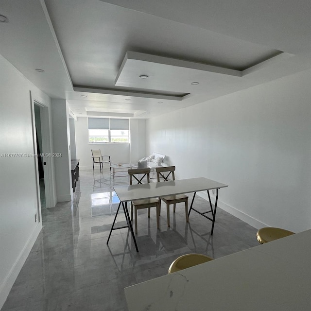 dining space featuring a raised ceiling