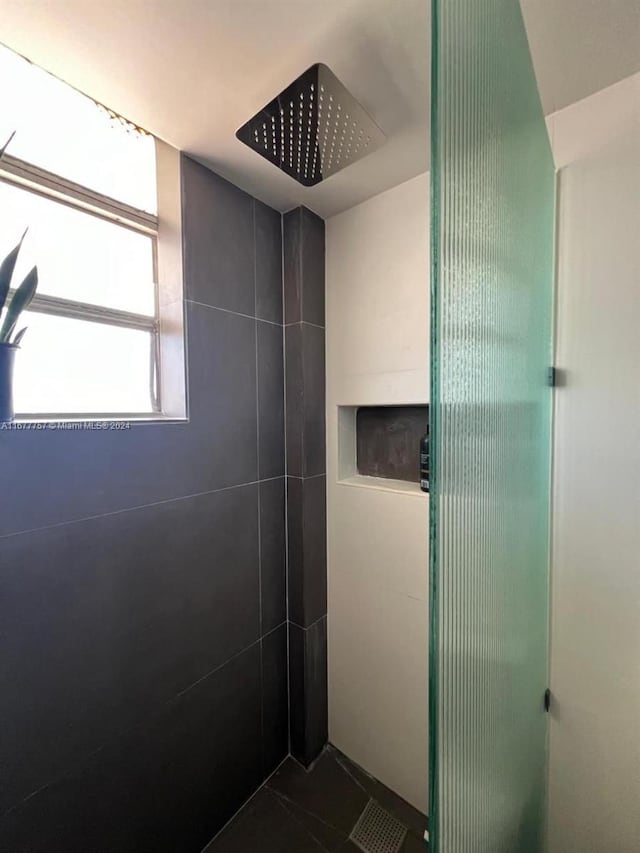 bathroom with a tile shower