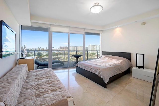 bedroom featuring expansive windows and access to outside