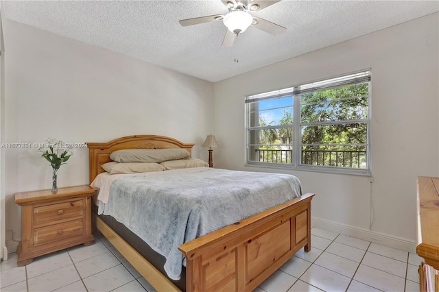 tiled bedroom featuring ceiling fan and a textured ceiling