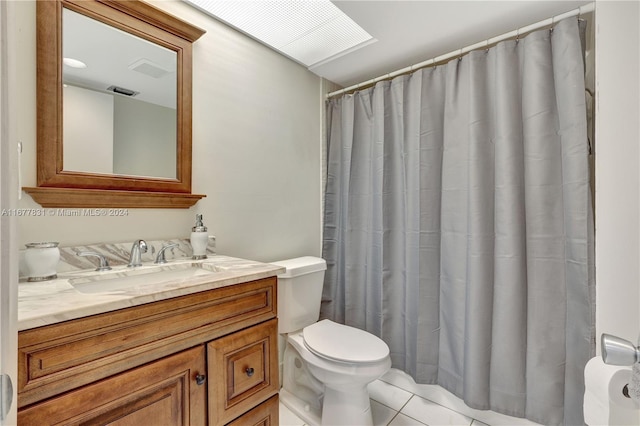 bathroom featuring toilet, vanity, and tile patterned flooring