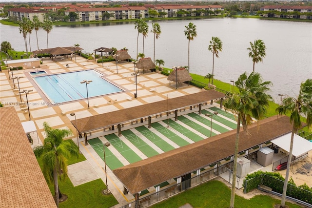 view of pool featuring a water view and a patio