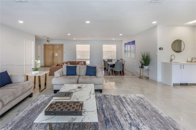 living room with sink and light tile patterned floors