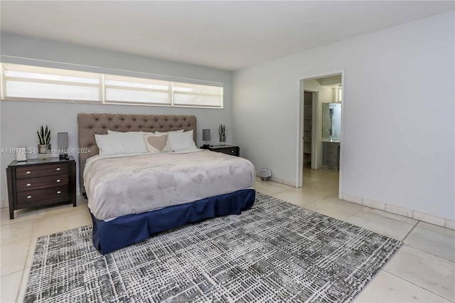 tiled bedroom featuring ensuite bath