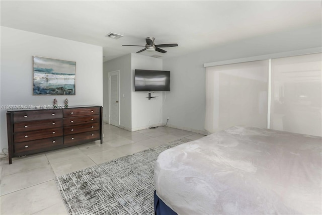 tiled bedroom featuring ceiling fan