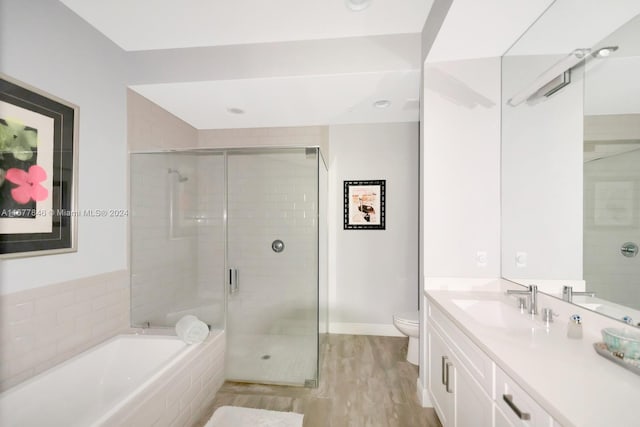 full bathroom featuring vanity, toilet, shower with separate bathtub, and hardwood / wood-style floors