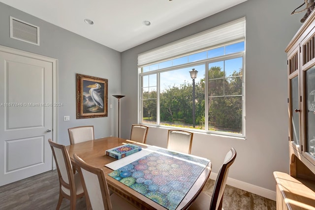 dining space with dark hardwood / wood-style flooring