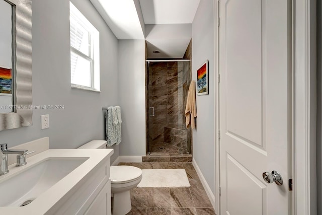 bathroom featuring vanity, toilet, and an enclosed shower