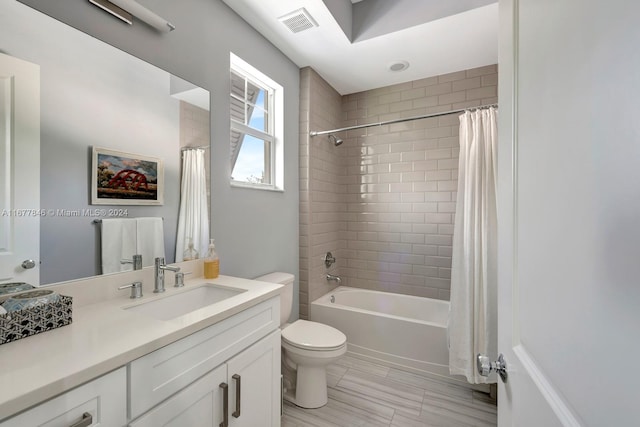 full bathroom featuring vanity, toilet, and shower / tub combo with curtain