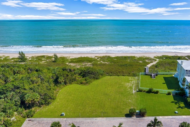 aerial view with a water view and a beach view