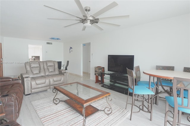 living room featuring ceiling fan and light wood-type flooring