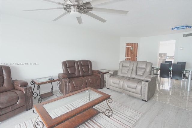 living room featuring light wood-type flooring and ceiling fan