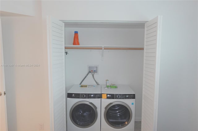 clothes washing area featuring washer and dryer