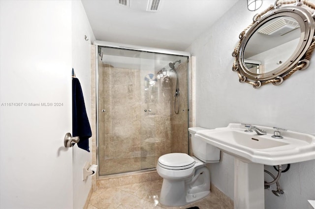 bathroom featuring toilet and a shower with shower door