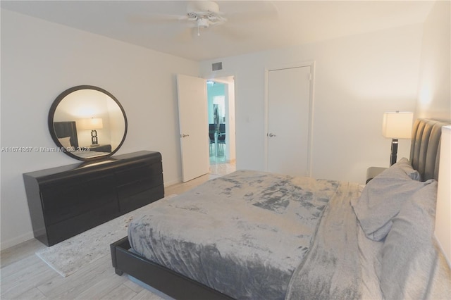 bedroom with light hardwood / wood-style floors and ceiling fan