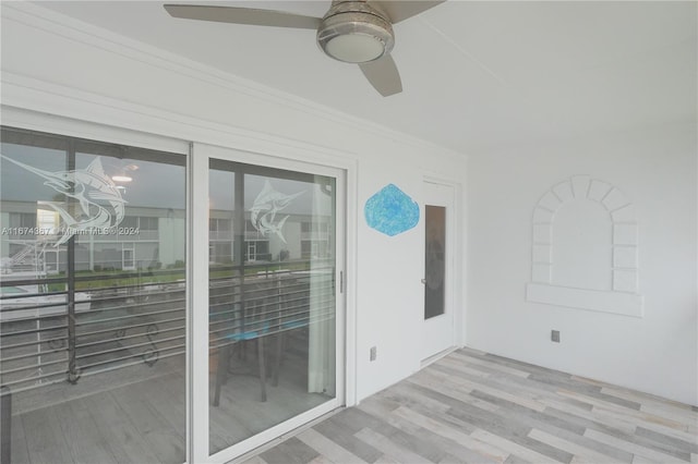 exterior space featuring crown molding, light hardwood / wood-style floors, and ceiling fan